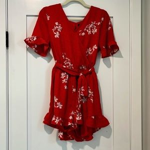 Romper, with ruffle detail on short and sleeve. Tie waste